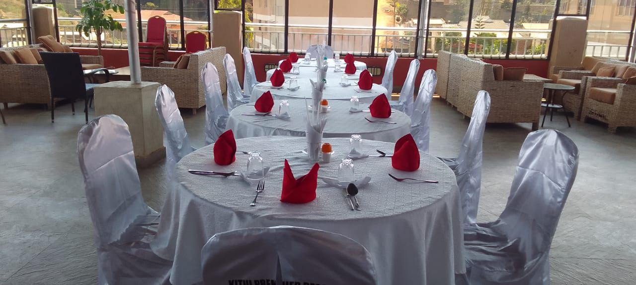 Elegant fine dining setup with silver chair covers and red napkins