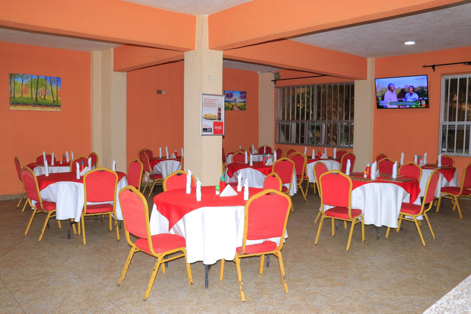 Bustani Restaurant indoor dining with orange walls and elegant table settings
