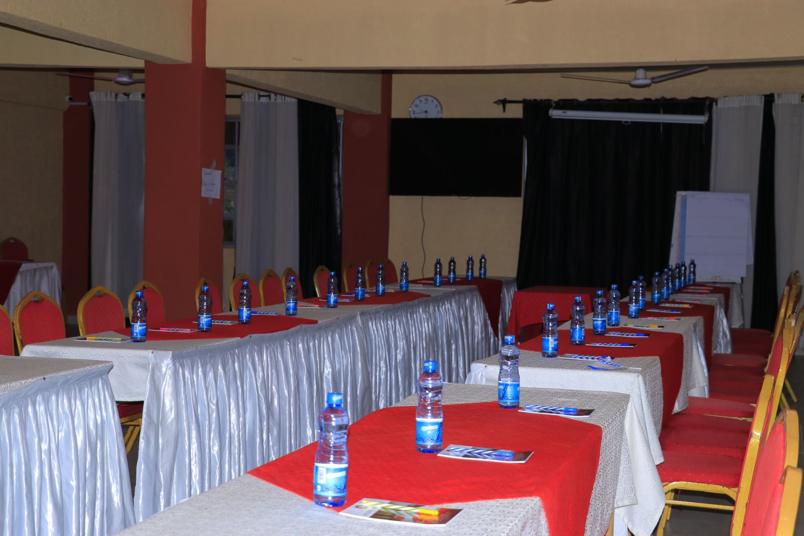 Conference room with classroom seating, presentation screen, and professional setup