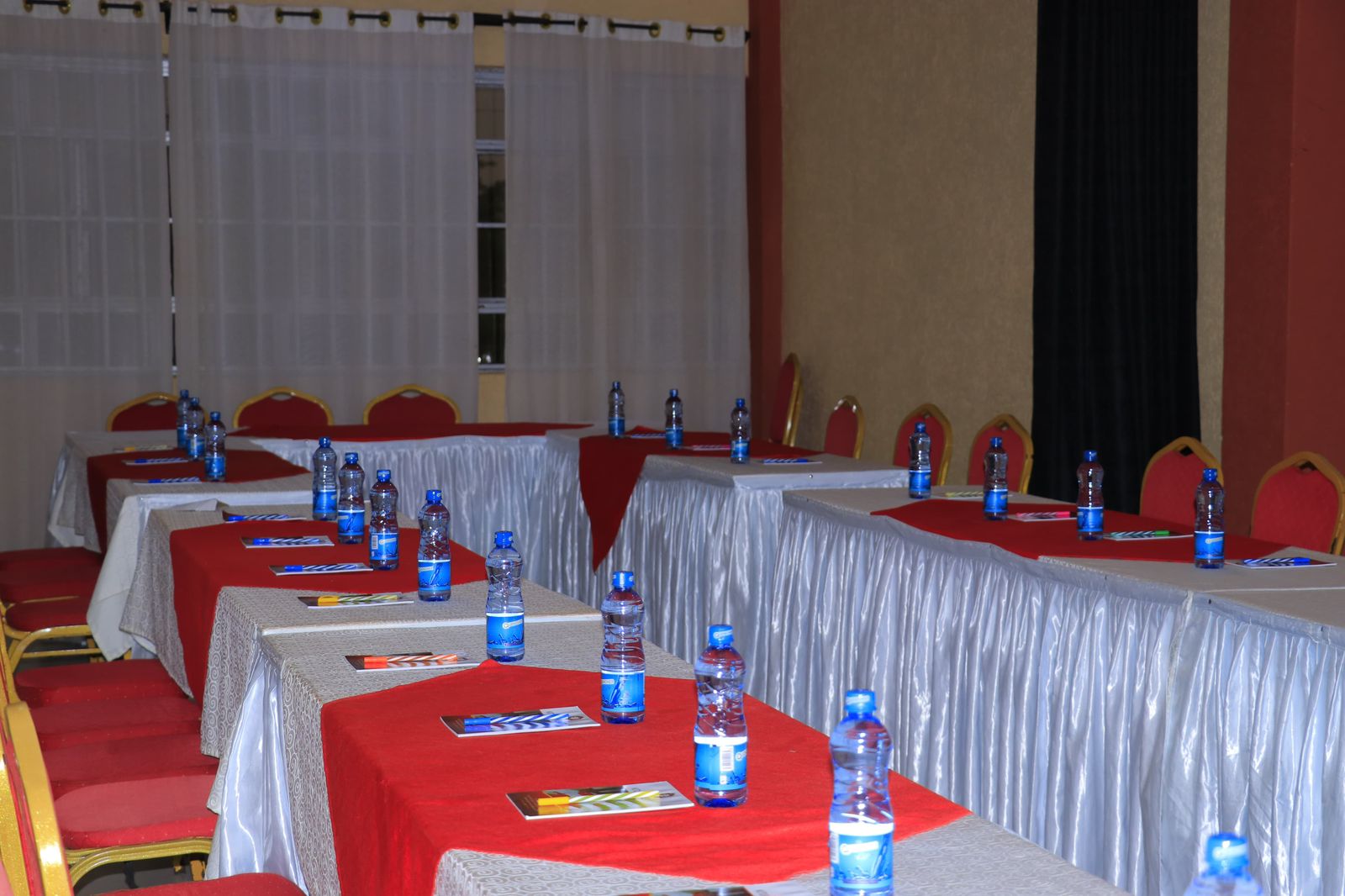 Conference room detail showing elegant table settings with water bottles and materials