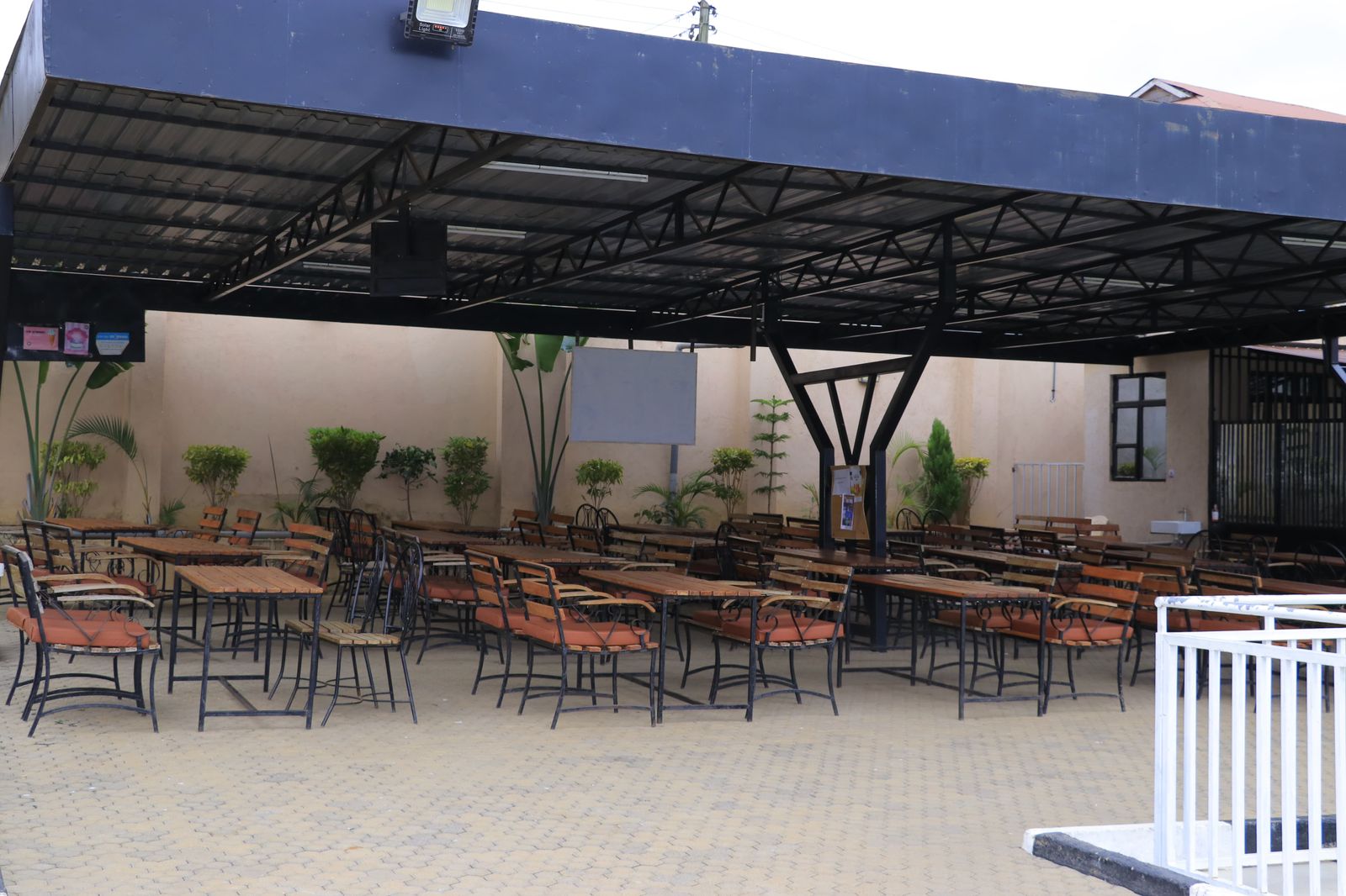 Outdoor covered dining area with potted plants