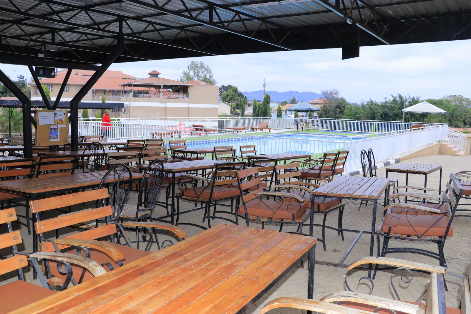 Poolside restaurant with wooden tables overlooking swimming pool